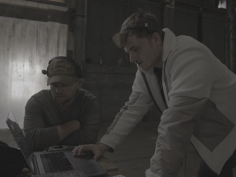 Nick Dean and Mitchell Mullins going over scenes from their film "Carry Us."